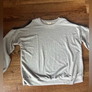 Sweater with open shoulder